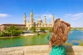 Amazing back view of attractive beautiful woman looking at Cathedral Basilica of Our Lady of the Pillar in Zaragoza, Spain