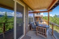 Amazing balcony patio with fire pit and forest and mountains view. Dream come true home exterior. New AMerican architecture. Royalty Free Stock Photo