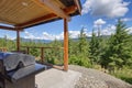 Amazing balcony patio with fire pit and forest and mountains view. Dream come true home exterior. New AMerican architecture. Royalty Free Stock Photo