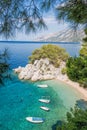 Beach with boats against azure sea in Brela, Makarska, Dalmatia, Croatian coast Royalty Free Stock Photo