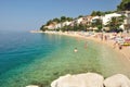 Amazing beach with people, apartments and palm trees in Podgora-Caklje