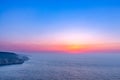 Amazing beach sunset with endless horizon and lonely figures in the distance, and incredible foamy waves. Royalty Free Stock Photo