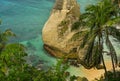 Beautiful and idyllic scenic view of sea landscape at tropical island paradise beach with diamond shape rock cliff palm trees and Royalty Free Stock Photo