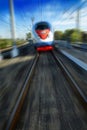 Amazing beautiful impressive front view on moving white red blue beautiful high speed passenger train in motion blur. High speed Royalty Free Stock Photo