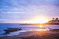 Amazing beautiful timeless sunset on the beach with ocean and palms in backgorund. nice colors from orange to deep blue. relax and