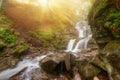 Amazing beauty of Alps mountains waterfall. Summer waterfall in Alps with soft sun rays at evening Royalty Free Stock Photo