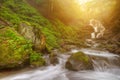 Amazing beauty of Alps mountains waterfall. Summer waterfall in Alps with soft sunlight at evening Royalty Free Stock Photo