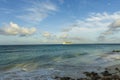 Amazing beauty  Atlantic ocean turquoise water surface. Big cruise boat merging with blue sky and white clouds. Aruba island. Royalty Free Stock Photo