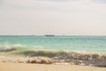 Amazing beauty  Atlantic ocean turquoise water surface. Boat merging with blue sky and white clouds. Aruba island. Royalty Free Stock Photo