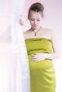 Amazing beauty pregnant woman behind curtain