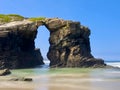 Amazing big hole in rock. Eroded beach coastline. Cathedral Beach. Playa de las Catedrales, Spain