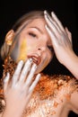 Amazing blonde model with professional makeup and gold foil on h Royalty Free Stock Photo