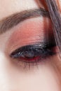 Amazing Bright eye makeup with a wide arrow. Brown and red tones, colored eyeshadow. Royalty Free Stock Photo