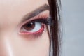 Amazing Bright eye makeup with a wide arrow. Brown and red tones, colored eyeshadow. Royalty Free Stock Photo