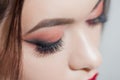 Amazing Bright eye makeup with a wide arrow. Brown and red tones, colored eyeshadow. Royalty Free Stock Photo