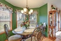 Amazing bright green breakfast nook boasts wrought iron table set Royalty Free Stock Photo