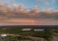 A brilliant rainbow at sunset over lake with forest