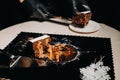 Amazing Cakes. A black-gloved chef is slicing a chocolate wedding cake. The wedding Cake is delicious inside on a black background Royalty Free Stock Photo