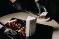 Amazing Cakes. A black-gloved chef is slicing a chocolate wedding cake. The wedding Cake is delicious inside on a black background Royalty Free Stock Photo