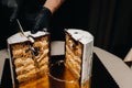 Amazing Cakes. A black-gloved chef is slicing a chocolate wedding cake. The wedding Cake is delicious inside on a black background Royalty Free Stock Photo