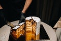 Amazing Cakes. A black-gloved chef is slicing a chocolate wedding cake. The wedding Cake is delicious inside on a black background Royalty Free Stock Photo