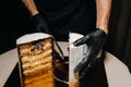 Amazing Cakes. A black-gloved chef is slicing a chocolate wedding cake. The wedding Cake is delicious inside on a black background Royalty Free Stock Photo