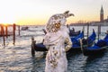 Amazing carnival mask against gondolas in Venice, Italy Royalty Free Stock Photo