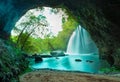 Amazing cave in deep forest with beautiful waterfalls background