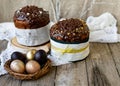 Amazing Chocolate Easter Cake with chocolate drops and dry cherries on an old wooden background with black and golden eggs. Easter