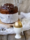 Amazing Chocolate Easter Cake with chocolate drops and dry cherries on an old wooden background with black and golden eggs. Easter