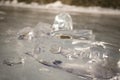 Amazing chunks of ice in the skylight. Transparent ice with cracks covered with snow. Hummocks of frozen Lake Baikal