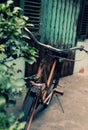 Amazing close up old bicycle front of antique house in vintage tone Royalty Free Stock Photo