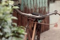 Amazing close up old bicycle front of antique house in vintage tone Royalty Free Stock Photo