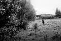 amazing clouds on sky and country side with girl, beautiful summer nature landscape, black and white Royalty Free Stock Photo