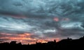 Amazing cloudy sky sunrise. Dark orange storm scary dramatic clouds in beautiful sunrise with moving clouds over storm