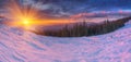 Amazing colorful sunrise in mountains with colored clouds and pink snow on foreground. . Dramatic winter scene with snow