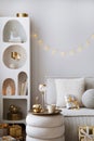 Amazing composition on white design shelf with christmas decoration, lights, gifts, lanterns ,deer, candles, stars, white corduroy Royalty Free Stock Photo
