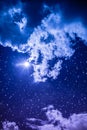 Amazing dark night sky with many stars, bright full moon and cloudy. Royalty Free Stock Photo