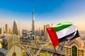 Amazing Dubai skyline cityscape with modern skyscrapers and UAE flag. Downtown of Dubai at sunny day, United Arab Emirates Royalty Free Stock Photo