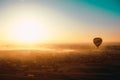 Amazing early morning sunrise view of a single balloon in luxor egypt, silhouette of the ballloon illuminated by the bright sun.