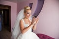 Amazing elegance cute stilysh blonde bride is posing on the bac