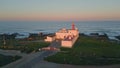 Amazing evening coastal lighthouse aerial view. Pink sky over beautiful ocean Royalty Free Stock Photo