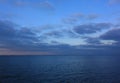 Amazing evening landscape of the sea. Ash violet pink blue clouds floating across the sky and dark sea. Royalty Free Stock Photo