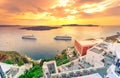 Amazing evening view of Fira, caldera, volcano of Santorini, Greece with cruise ships at sunset. Cloudy dramatic sky Royalty Free Stock Photo