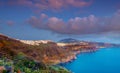 Amazing evening view of Fira, caldera, volcano of Santorini, Greece with cruise ships at sunset. Cloudy dramatic sky Royalty Free Stock Photo