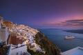 Amazing evening view of Fira, caldera, volcano of Santorini, Greece with cruise ships at sunset. Cloudy dramatic sky Royalty Free Stock Photo