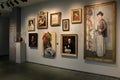 Several painted portraits, meticulously framed and hung on walls inside Memorial Art Gallery, Rochester, New York, 2017