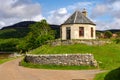 Amazing fairytale round house with road in beautiful Scottish nature.
