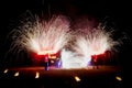 Amazing fire show dance. Fire dancers in beautiful costumes playing with colorful flames Royalty Free Stock Photo