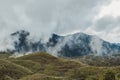 Amazing flowing morning fog mountains range in background with sunlight clouds and sky Royalty Free Stock Photo